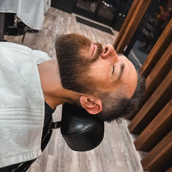 Barber shaving customer