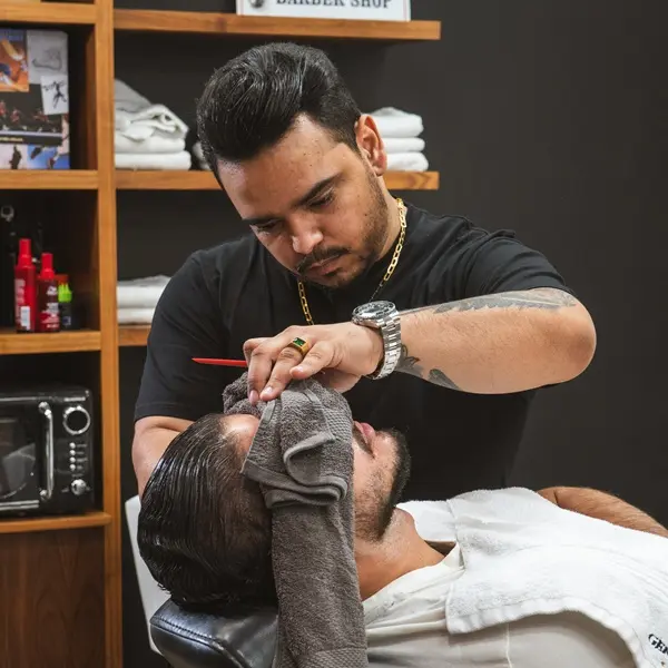 Barber shaving customer